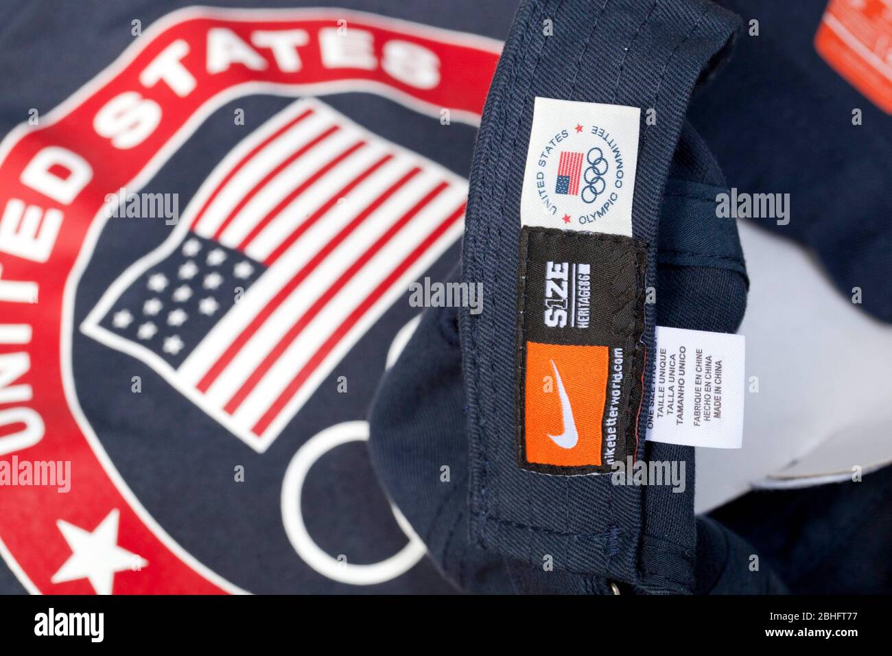 A 'Made in China' label and a U.S. Olympic Committee label adorn a United States Olympic Team-issued hat that was distributed to U.S. athletes and media in Dallas in May. In the background is a U.S. Olympic Team t-shirt that has a 'Made in Indonesia' label. ©Bob Daemmrich Stock Photo