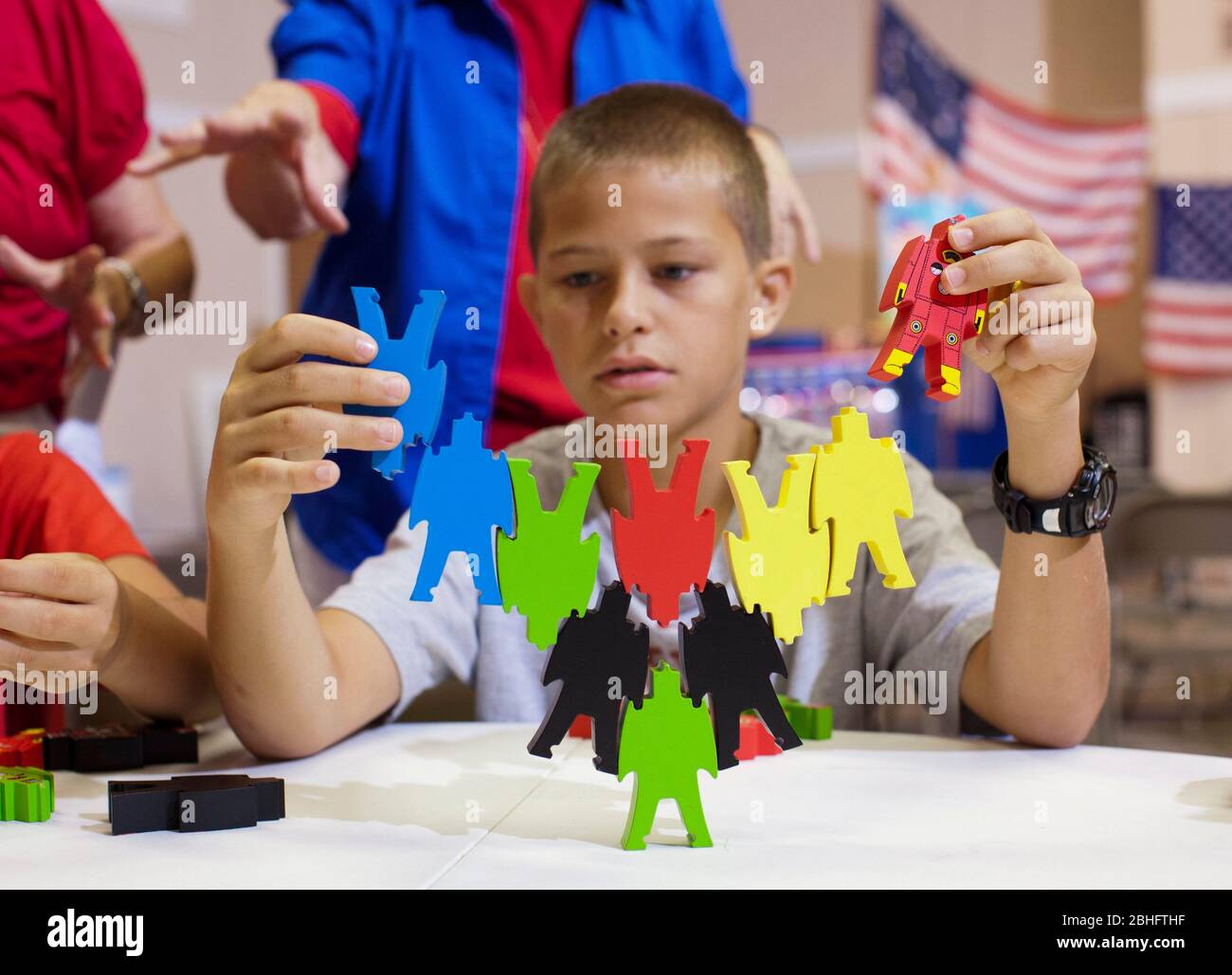 Georgetown Texas USA, August 17 2012: A student builds a toy structure that purports to show the 'instability of a government built around one person' during a week-long 'Vacation Liberty School' that teaches children ages 7-12 'the benefits of liberty from the perspective of faith, hope and charity.' ©Bob Daemmrich Stock Photo