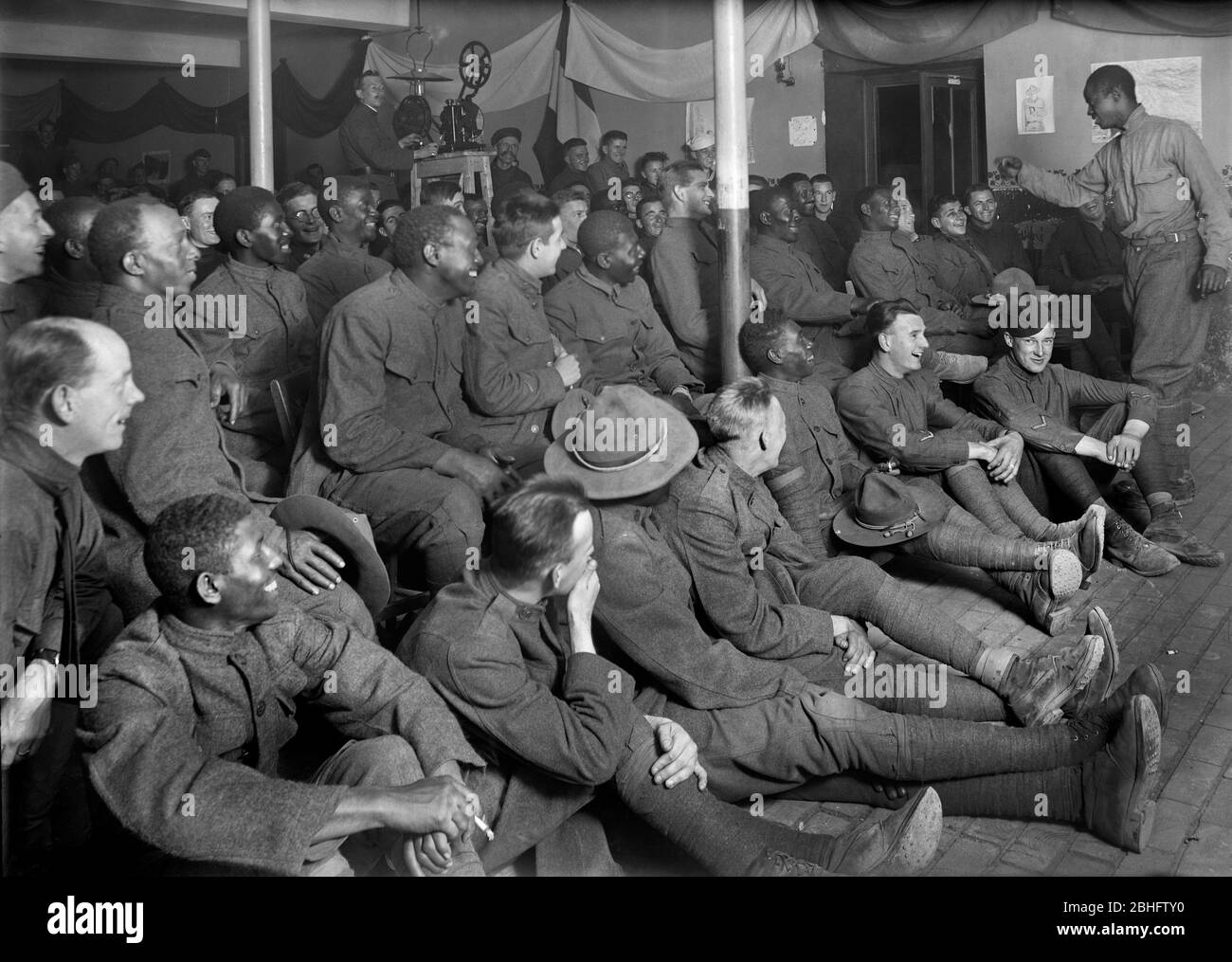 American Soldier entertaining Group of American Soldiers, American Red Cross, Recreation Hut, Orleans, France, September 1918 Stock Photo
