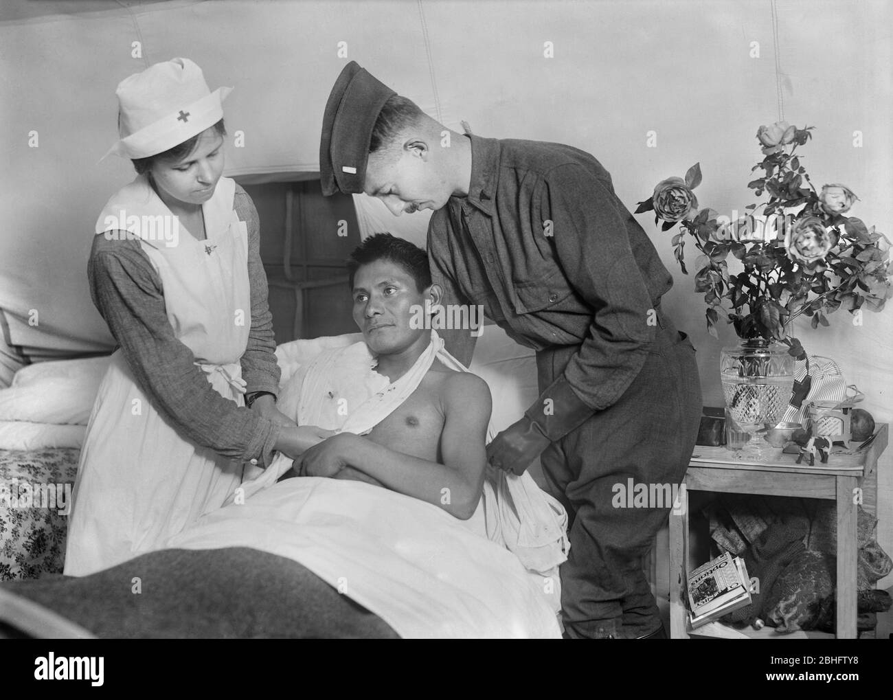 Wounded American Soldier, a Choctaw Native American from Oklahoma, being tended to by Surgeon and Nurse at American Military Hospital No. 5, a Tent Hospital supported by American Red Cross, Auteuil, France, Lewis Wickes Hine, American National Red Cross Photograph Collection, September 1918 Stock Photo