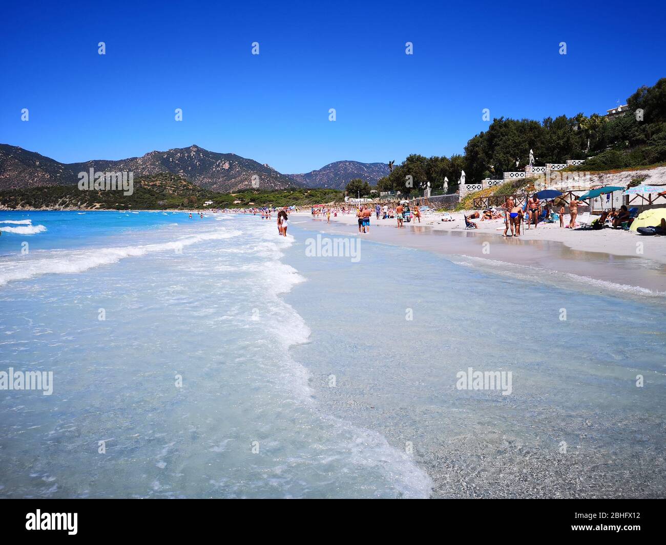 Villasimius, Italy - August 14, 2019: Blue and transparent water and the light sand of a beach in Sardinia. Stock Photo