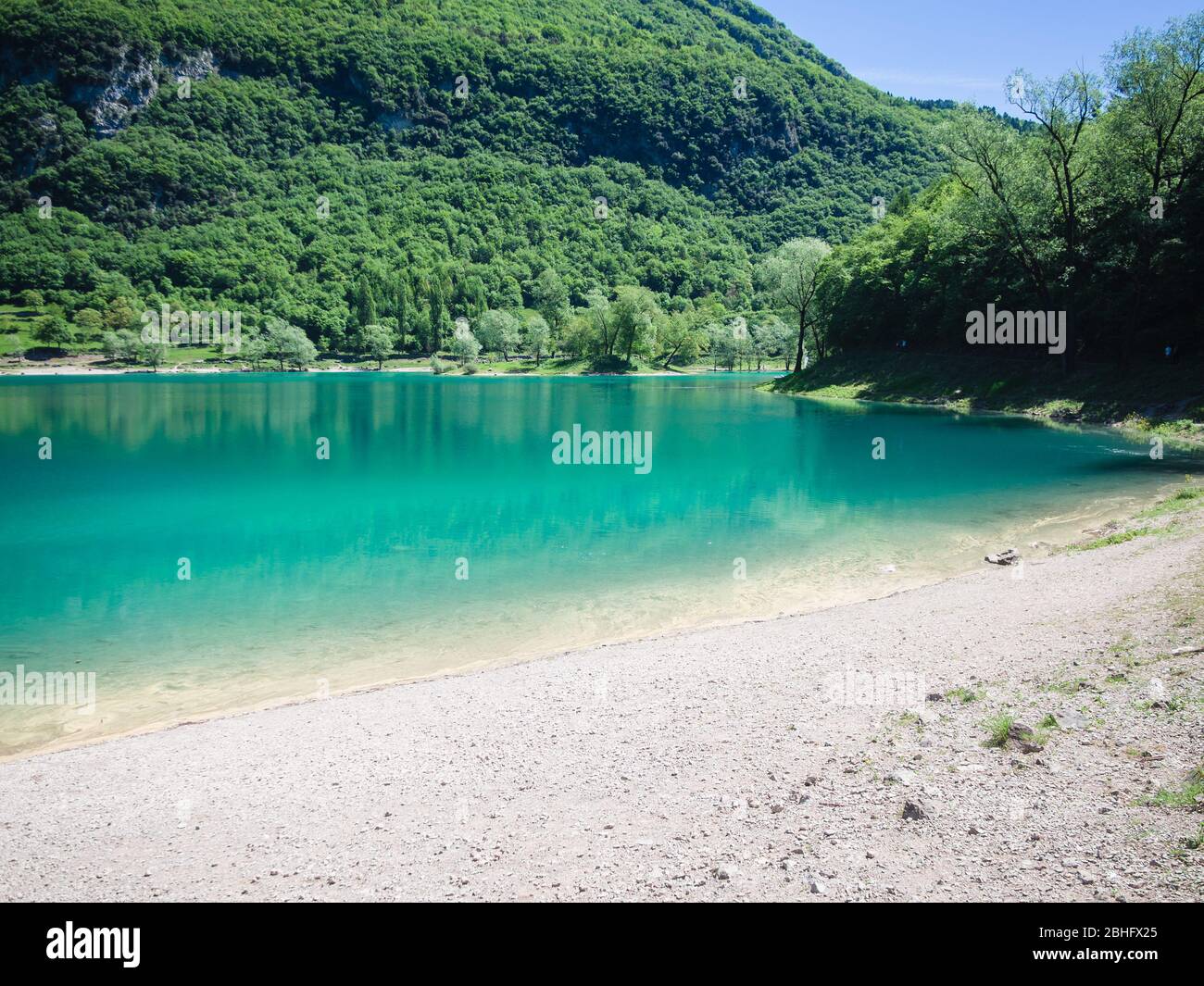 Panorama of Lake Tenno surrounded by Italian mountains. Stock Photo