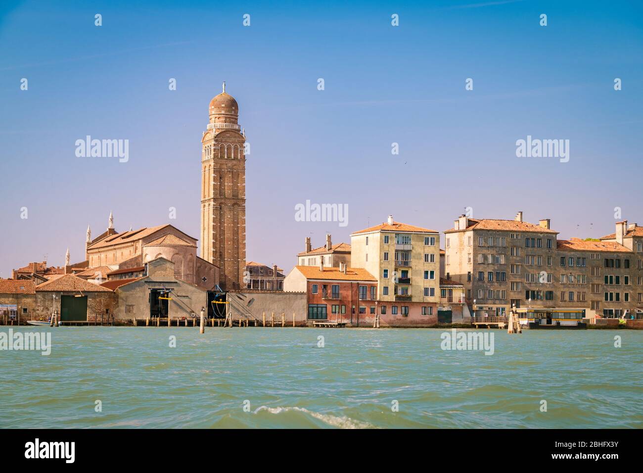 The bell tower of the church of San Pietro Martire in Venice at sunset seen from the sea. Stock Photo