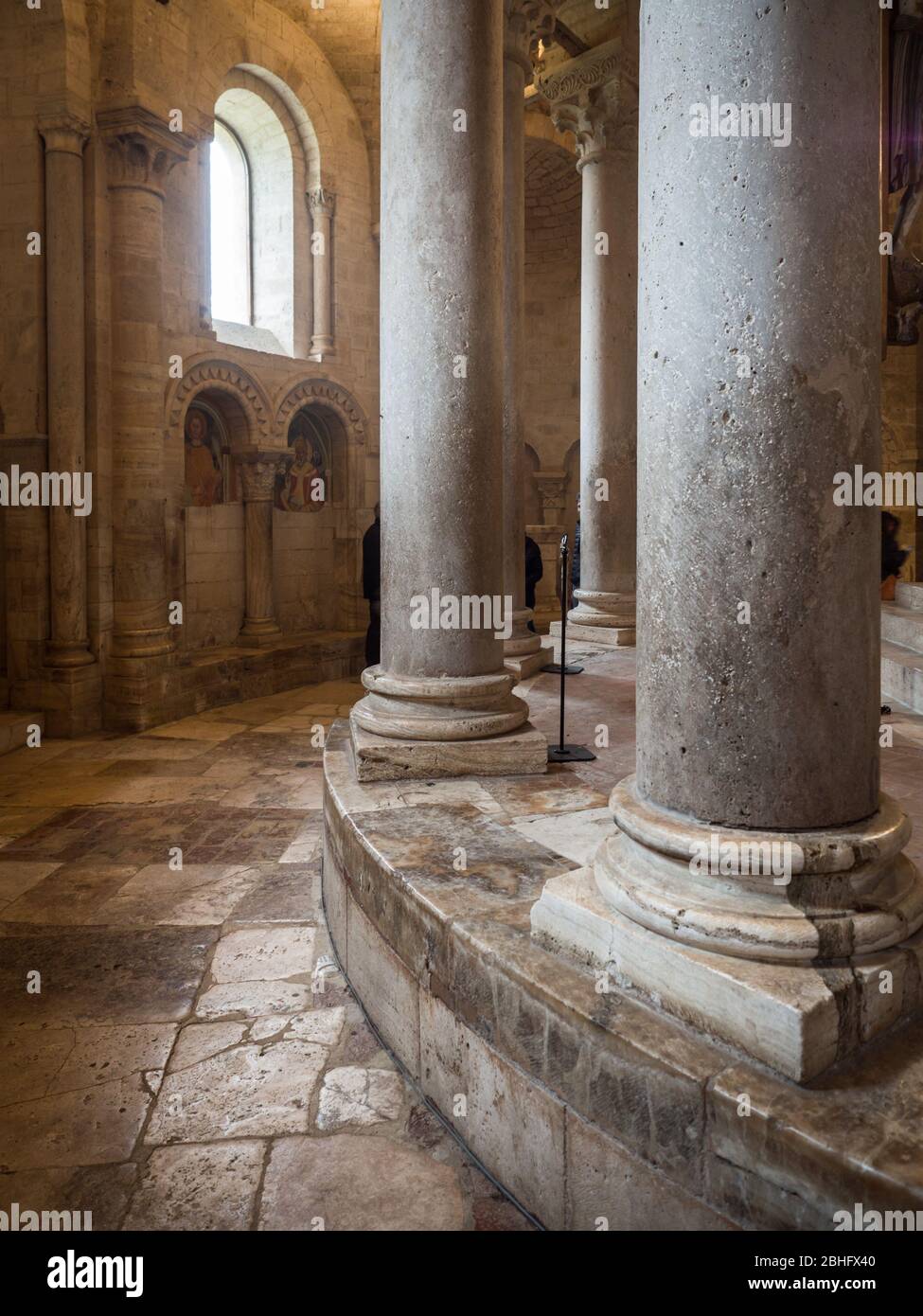 Montalcino, Italy - April 22, 2019: Detail of the columns arranged in a circle around the altar of an ancient medieval church. Stock Photo