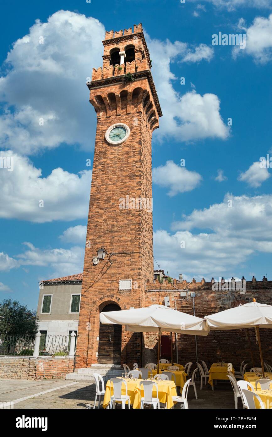 Brick bell tower of the church of San Giacomo in Murano, Venice lagoon island, Italy. Stock Photo