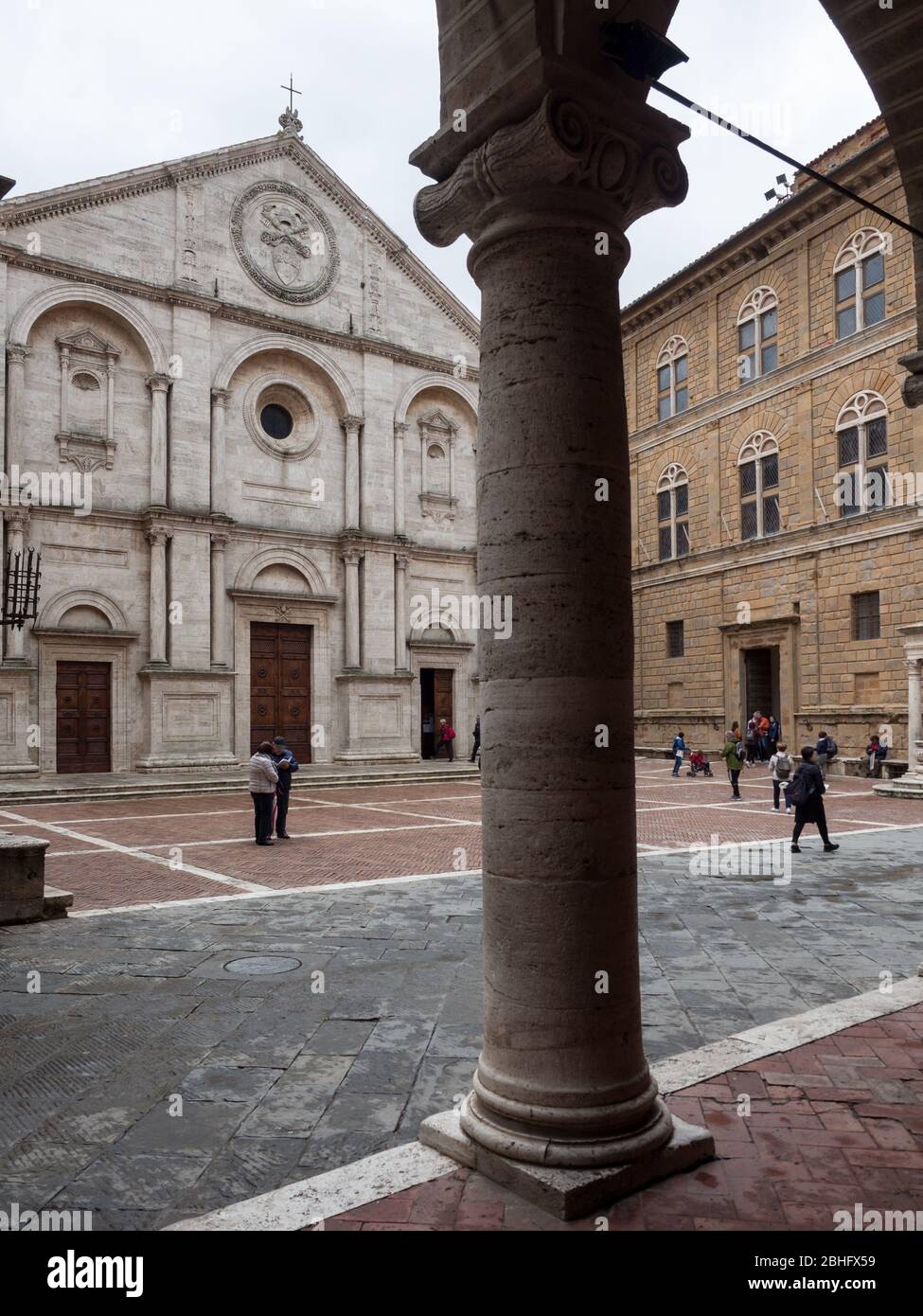 The cathedral of Santa Maria Assunta is the main place of worship in Pienza. View from the opposite colonnade. Stock Photo