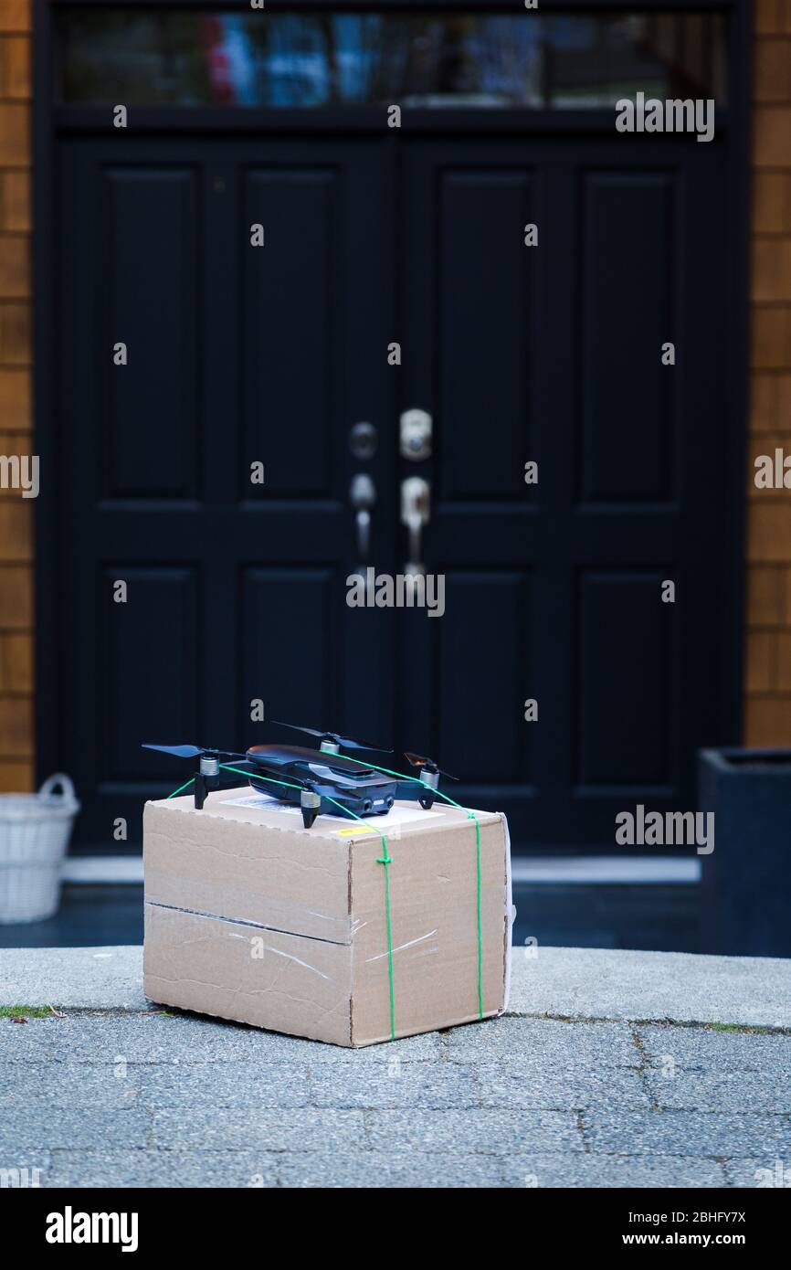 A package sitting in front of a residence that has been delivered by an autonomous drone. Stock Photo
