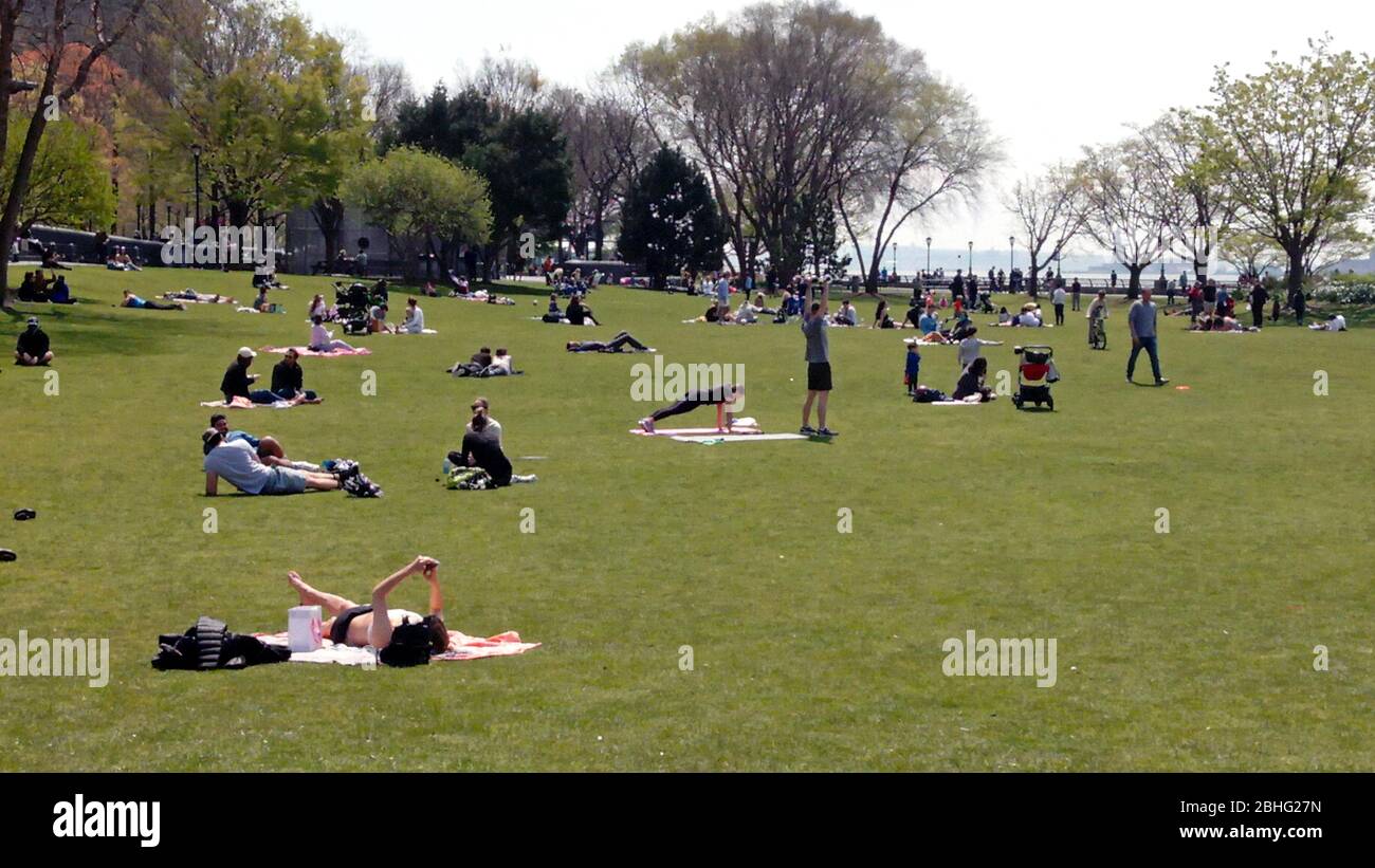 New York City, New York, United States. 25th Apr, 2020. Weather. New Yorkers eagerly took to Hudson River Park on a warm spring day this Saturday afternoon, some observing social distance and safety protocols more than others. Warm temperatures, and some hopeful signs that the worst may be over in New York City with COVID-19 infections for the moment, seemed to encourage people to take in some sun and recreation. Officials have warned against relaxing social distance and safety protocols prematurely. Credit: Adam Stoltman/Alamy Live News Stock Photo