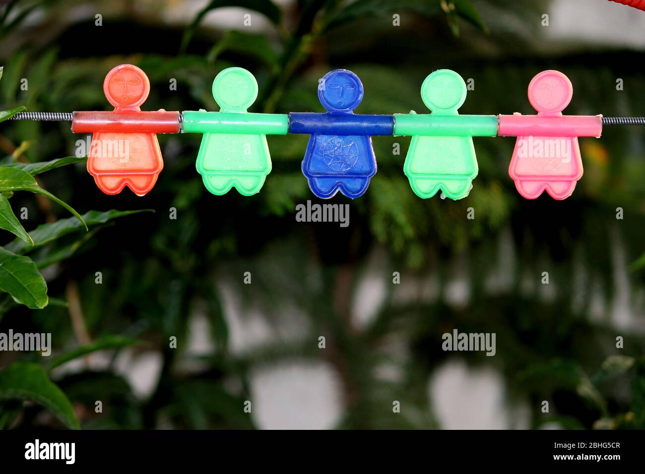 colorful hanging plastic character toy for kids playing, selective focus with blur background. Stock Photo