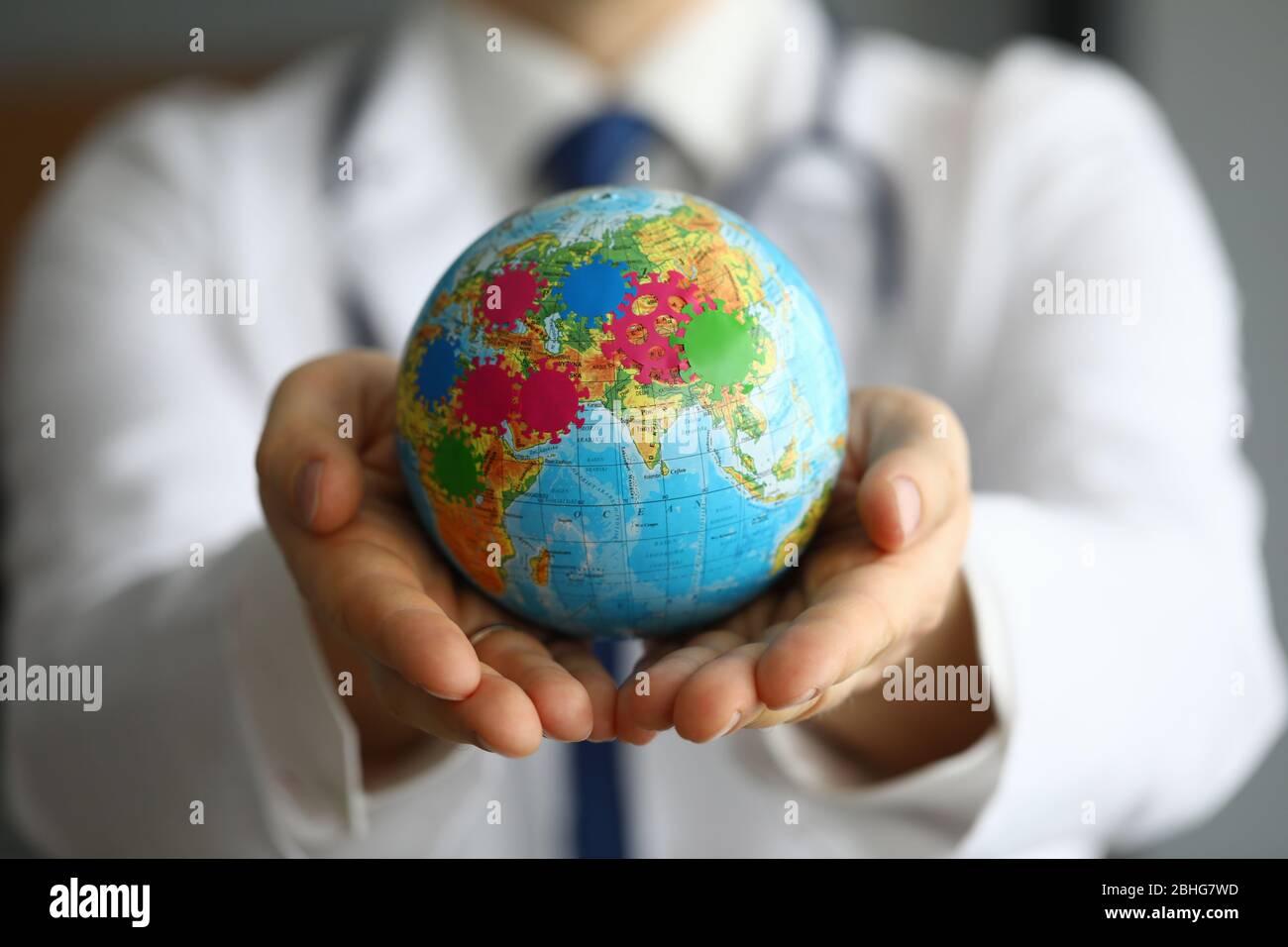 Doctor shows globe with coronavirus, world pandemic Stock Photo