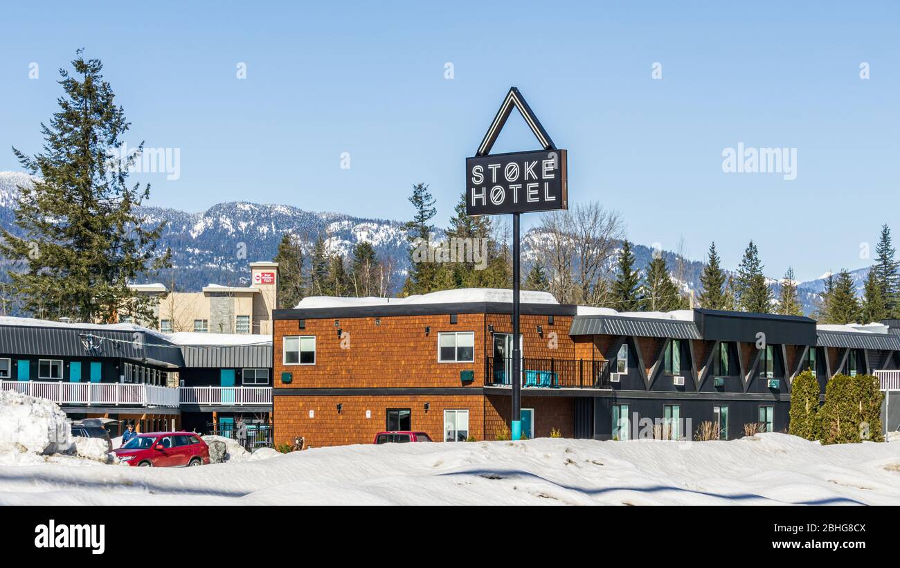 REVELSTOKE, CANADA - MARCH 15, 2020: hotel building in snow with mountains on background clear blue sky. Stock Photo