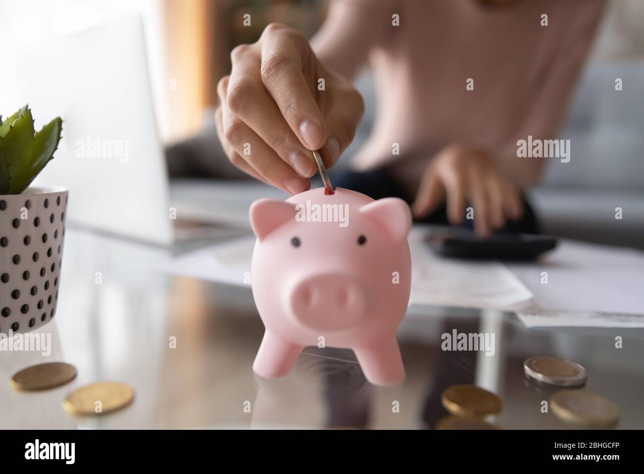 Woman saving money for household payments or utility bills. Stock Photo
