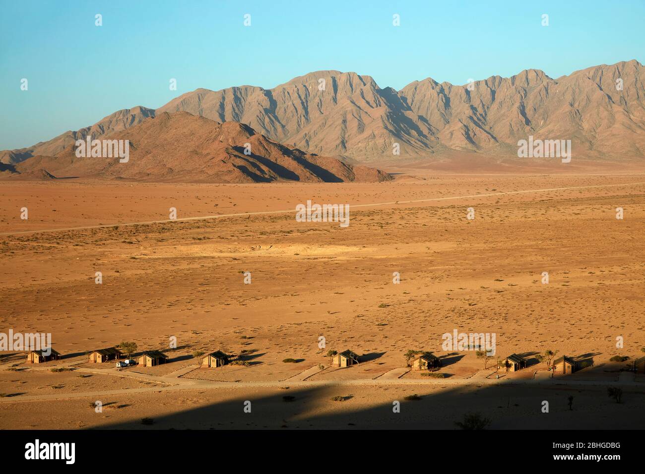 View of mountains and Desert Camp, from high on a rock koppie, Sesriem, Namib Desert, Namibia, Africa Stock Photo