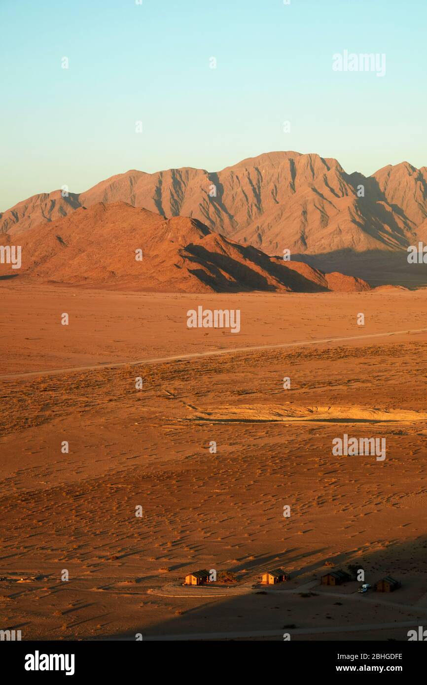 View of mountains and Desert Camp, from high on a rock koppie, Sesriem, Namib Desert, Namibia, Africa Stock Photo