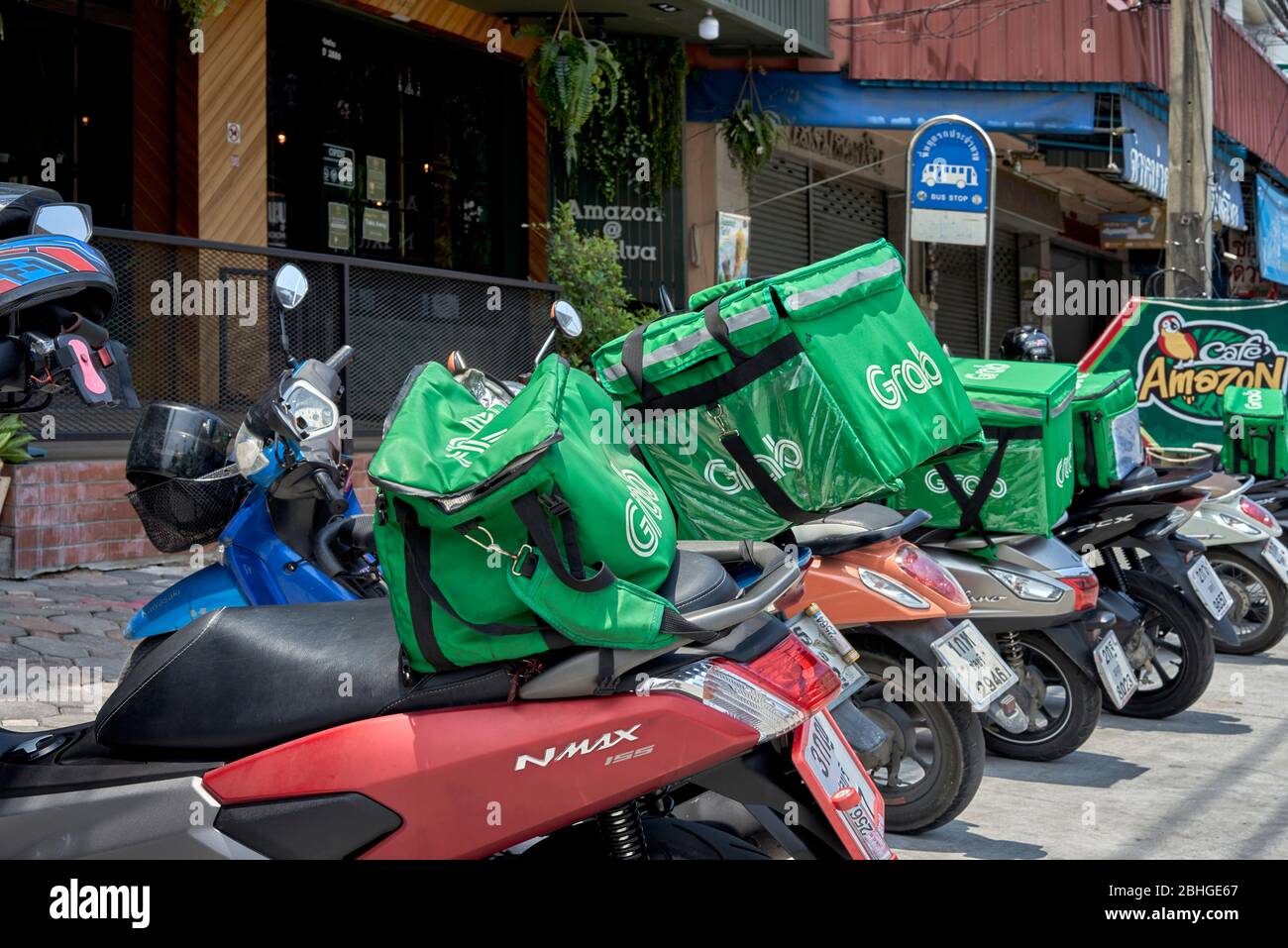 Grab food and drink delivery service at an Amazon coffee cafe awaiting  order requests. Thailand Southeast Asia Stock Photo - Alamy