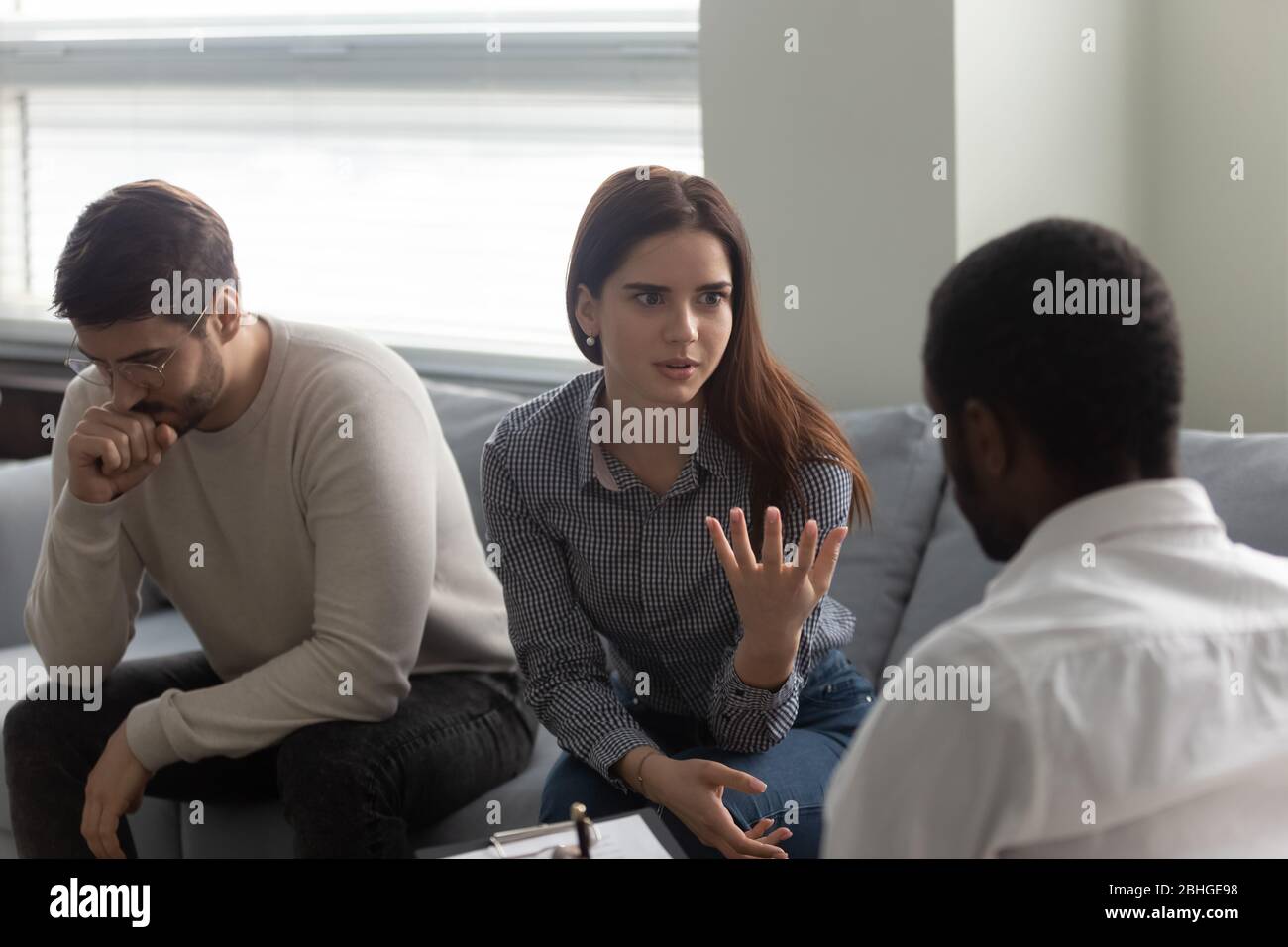 Argue woman with man at reception with family therapist. Stock Photo