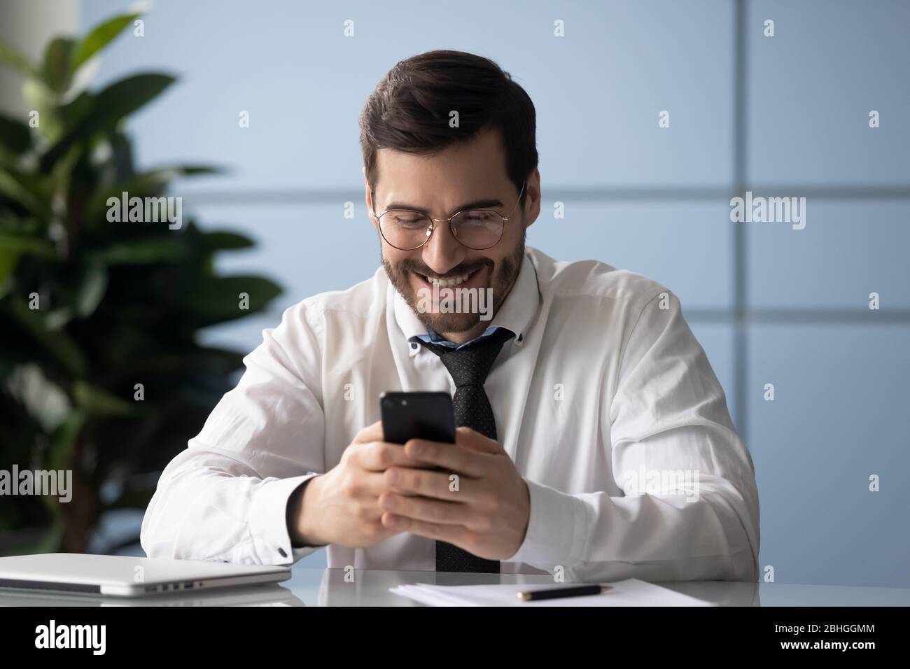 Happy businessman glad to good news message on smartphone Stock Photo ...