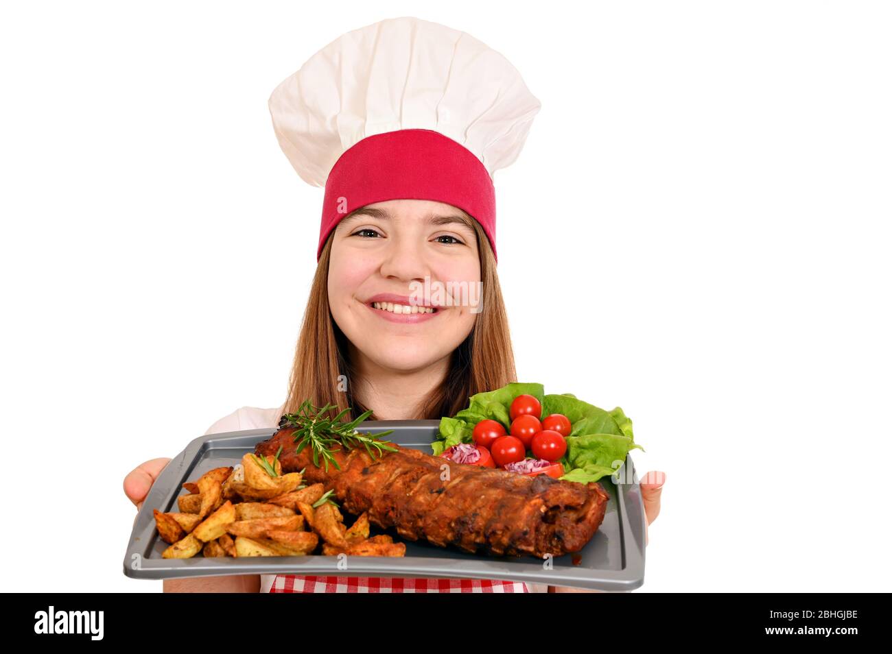 happy girl cook with pork ribs at plate Stock Photo
