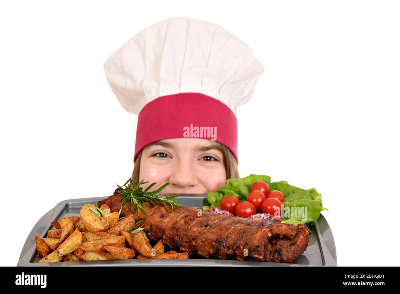 girl cook with pork spare ribs at plate Stock Photo