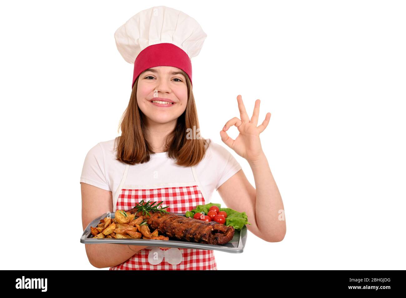 happy girl cook with pork ribs at plate and ok hand sign Stock Photo