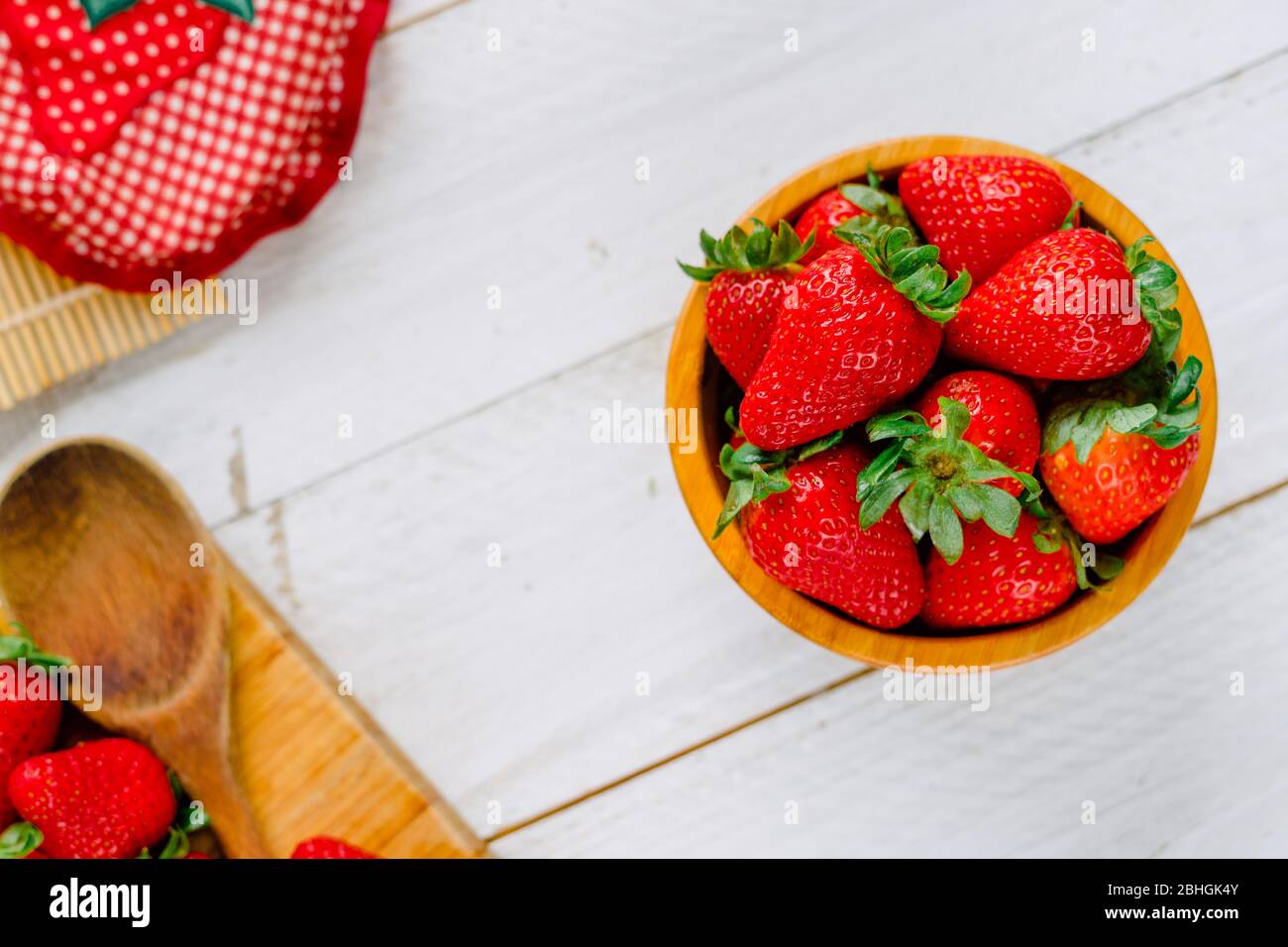Organic strawberries on a bowl on a white wooden table much colorful Stock Photo
