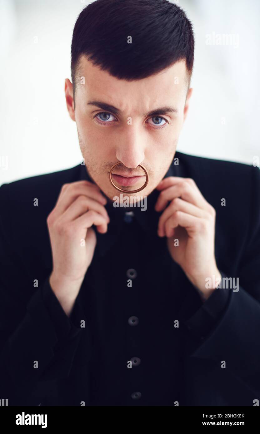 portrait of young man with nose piercing. goth subculture Stock Photo