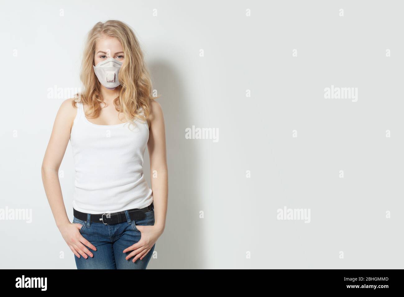 Young woman in medical face mask on white background Stock Photo - Alamy