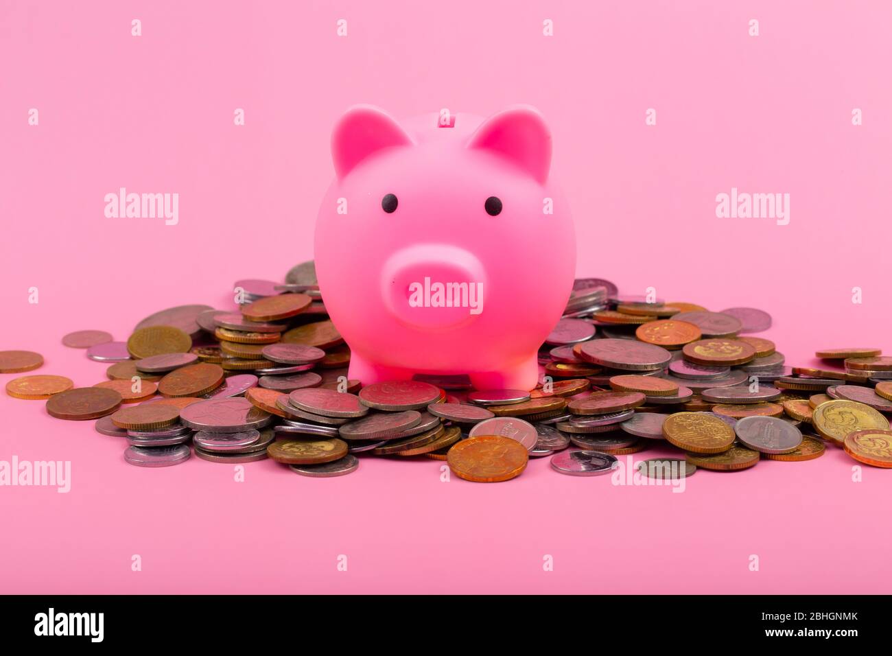 Coins with piggy bank on pink background -Saving Concept Stock Photo ...