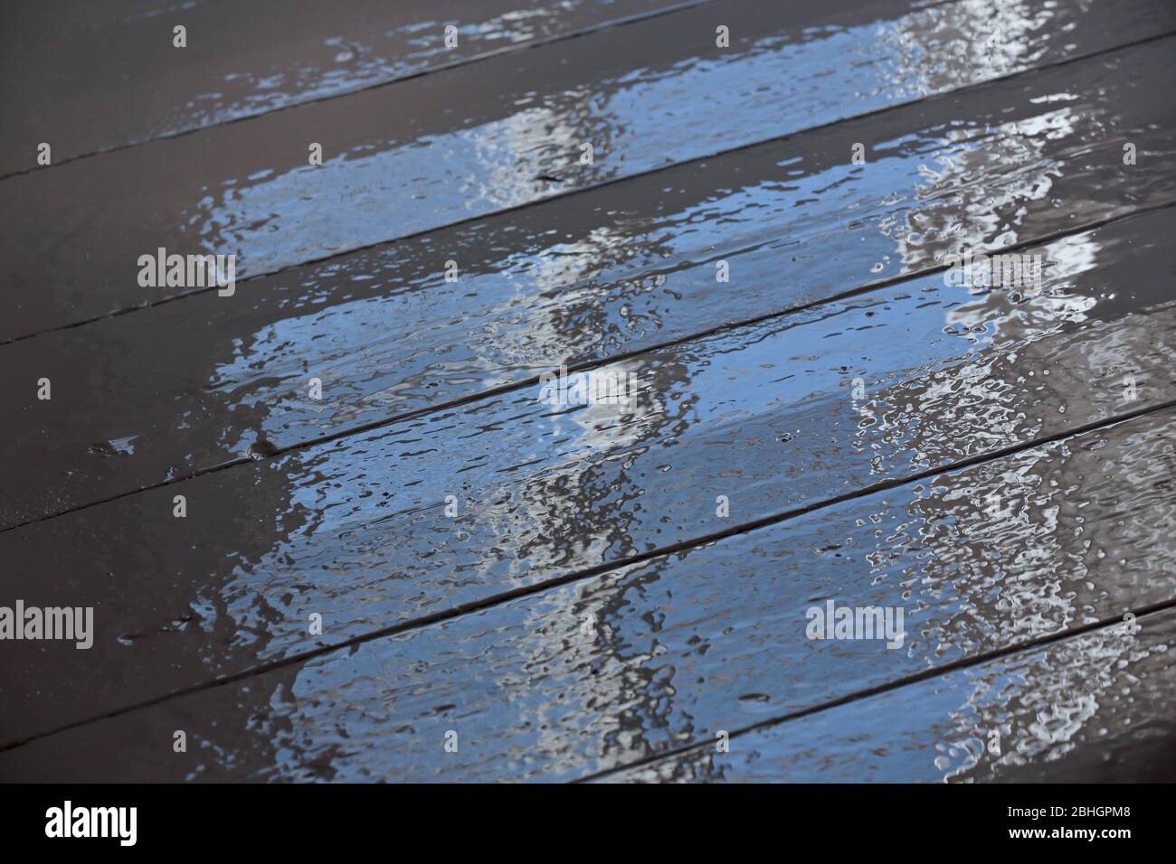 Wet painted floor reflects light from a window Stock Photo