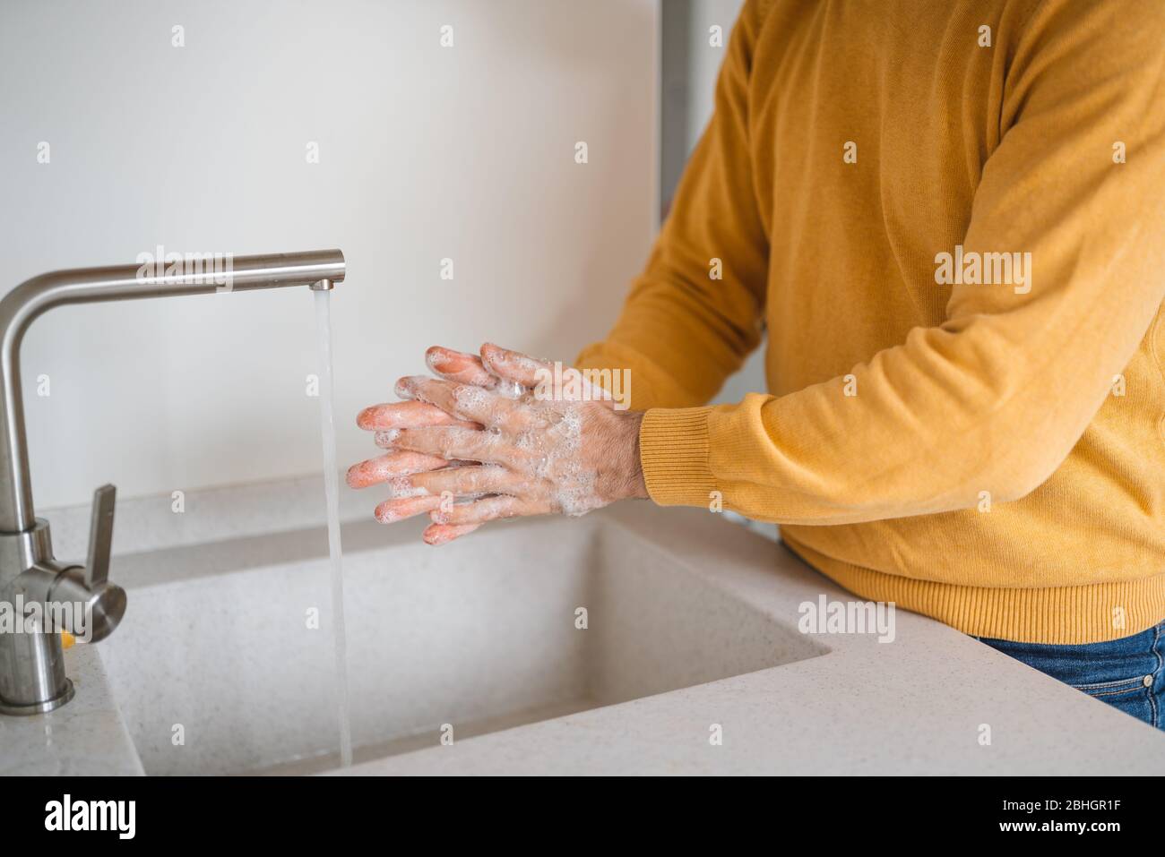 Coronavirus prevention. Man wash our hands with antibacterial soap. Stock Photo