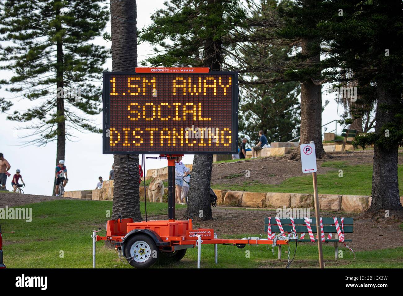 oronavirus Sydney, electronic sign at Avalon Beach in Sydney reminding people to maintain social distancing of 1.5 metres away,Australia Stock Photo