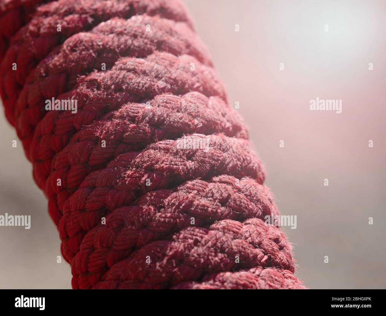 Red multi string construction nylon rope. The top view on a rope spiral ...