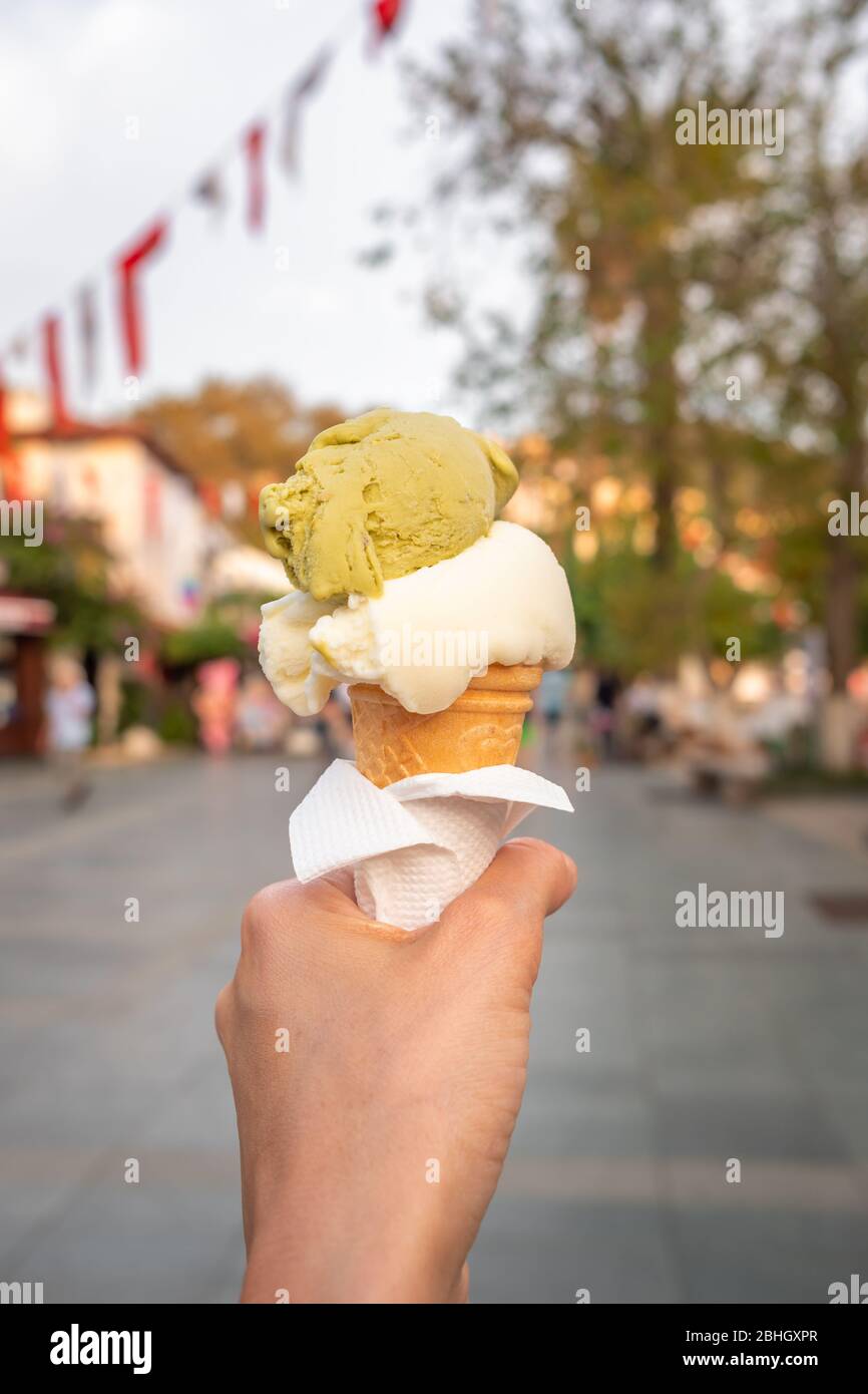 Turkish ice cream Dondurma in hand on the background of the Kas town Stock Photo