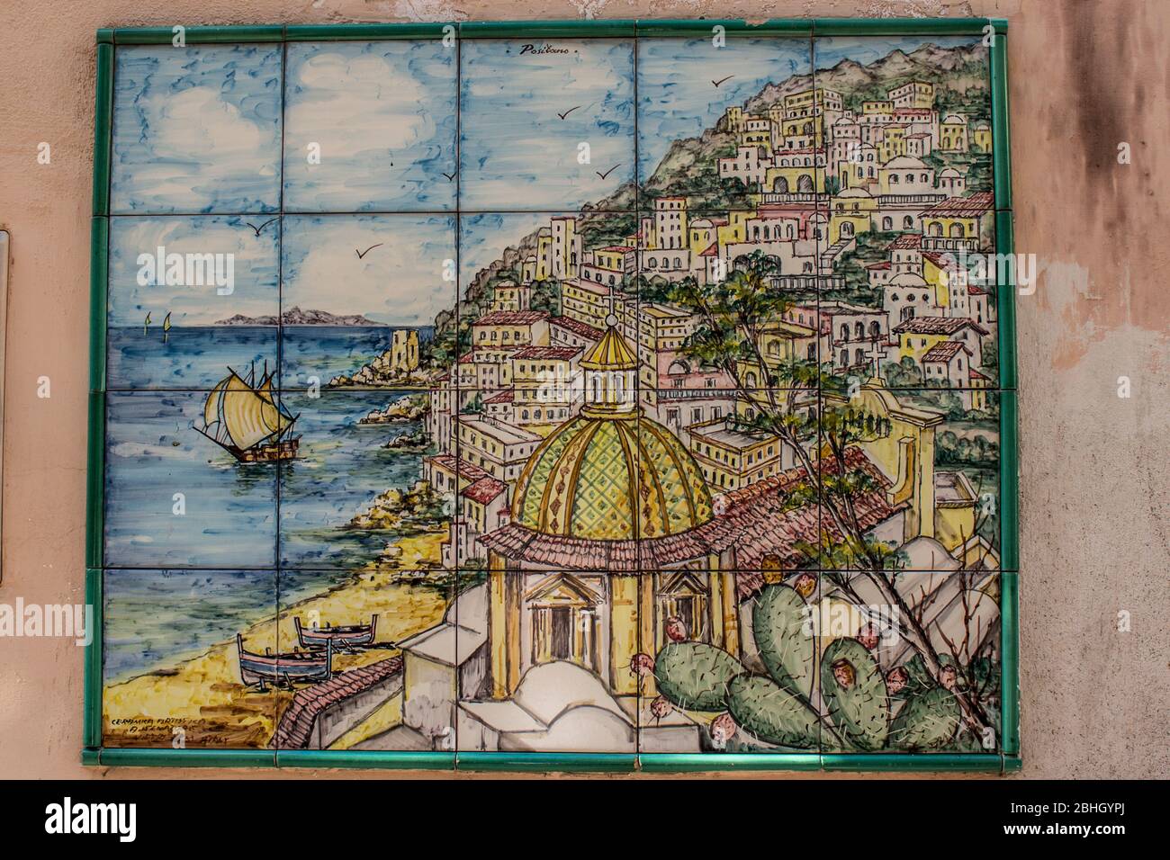 Typical Vietri sul mare ceramic tiles attached to the wall of a house along a narrow street in the city Stock Photo