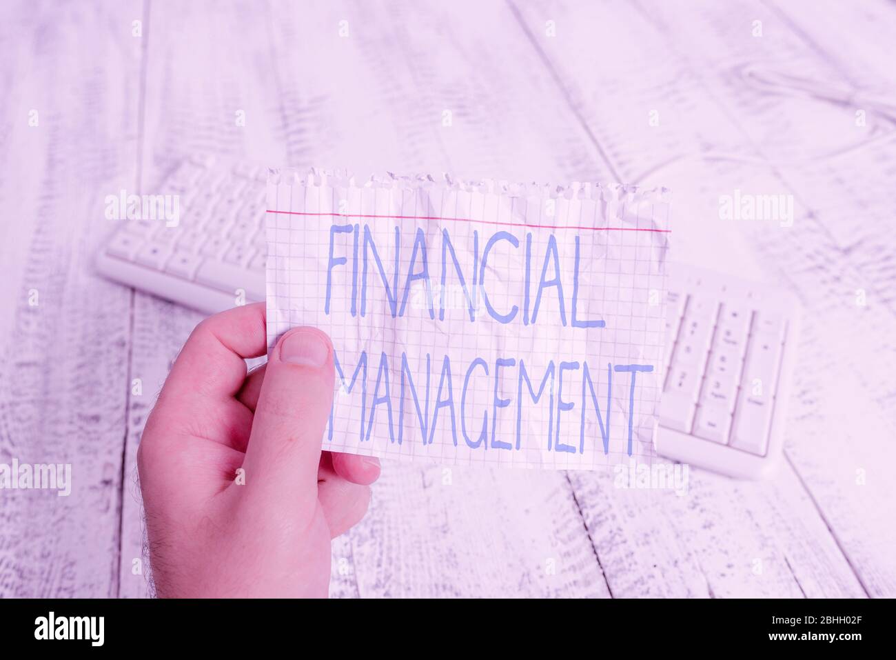 Conceptual hand writing showing Financial Management. Concept meaning efficient and effective way to Manage Money and Funds Man holding colorful remin Stock Photo