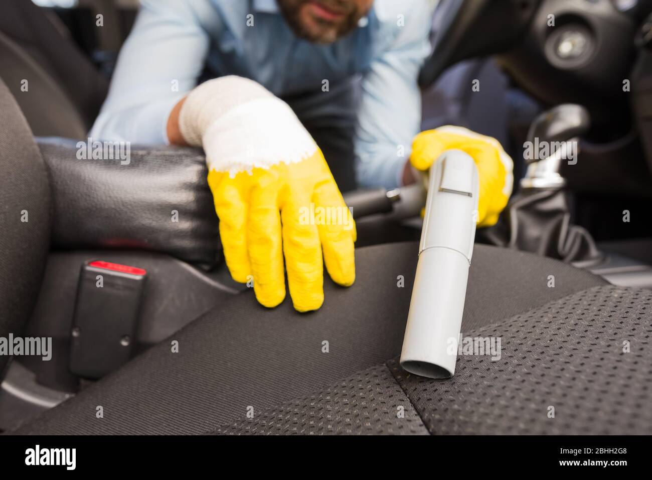 Close up of man cleaning car seat with vacuum cleaner Stock Photo Alamy