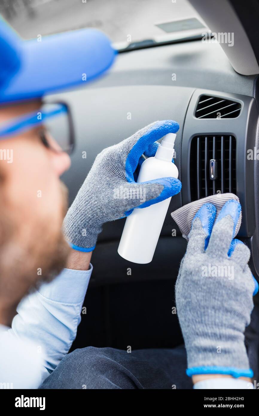 Professional Worker Using Disinfectant And Microfiber Cloth To Clean 