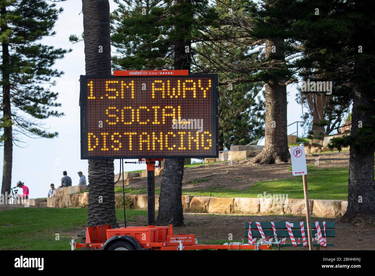 oronavirus Sydney, electronic sign at Avalon Beach in Sydney reminding people to maintain social distancing of 1.5 metres away,Australia Stock Photo