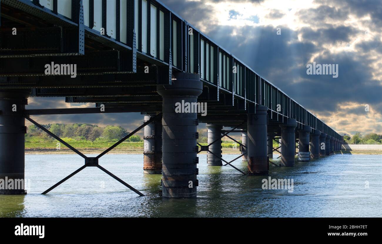 shoreham railway bridge over water with moody sky Stock Photo
