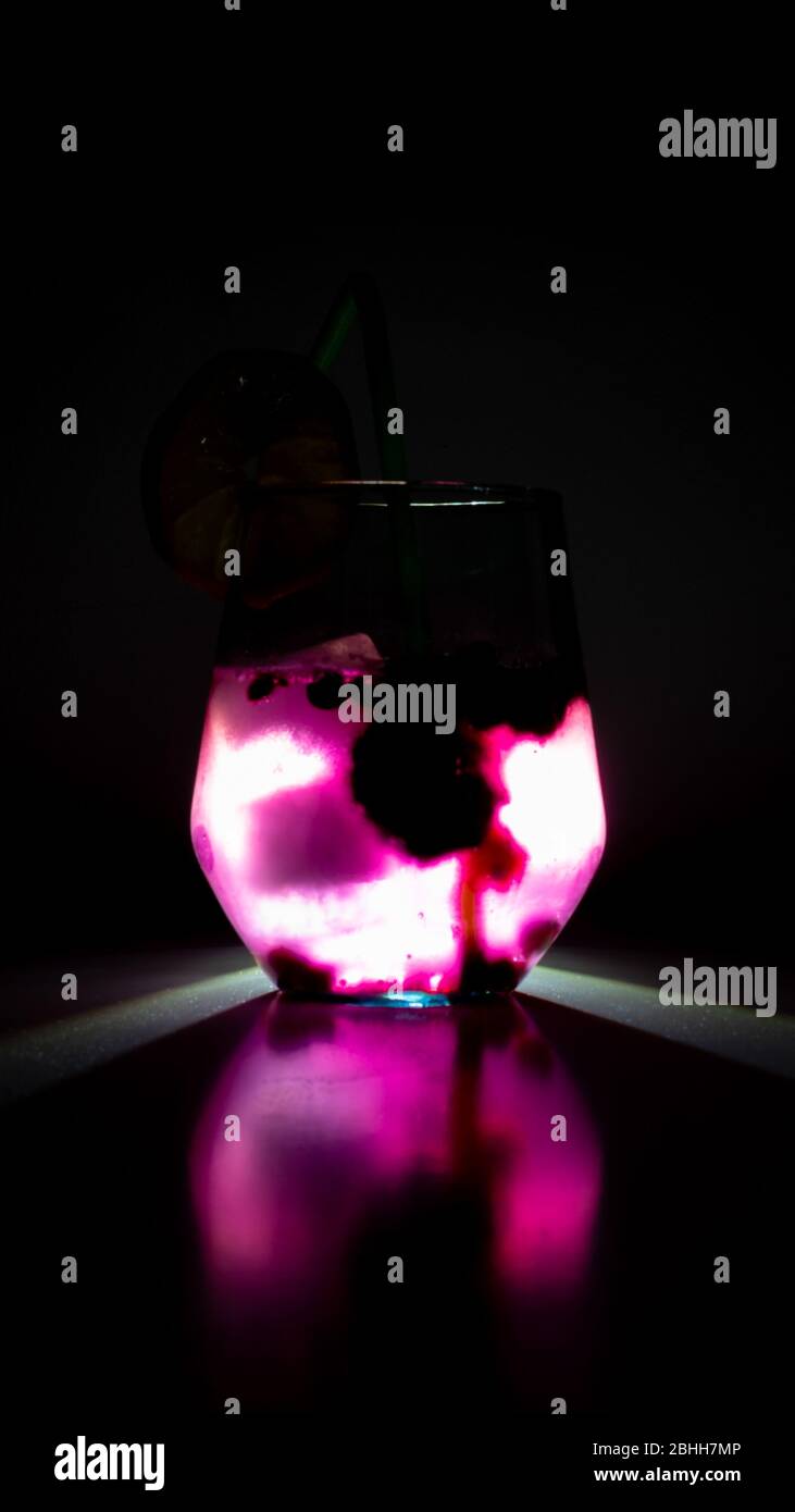 blueberry juice with ice cubes, back light, dark Stock Photo