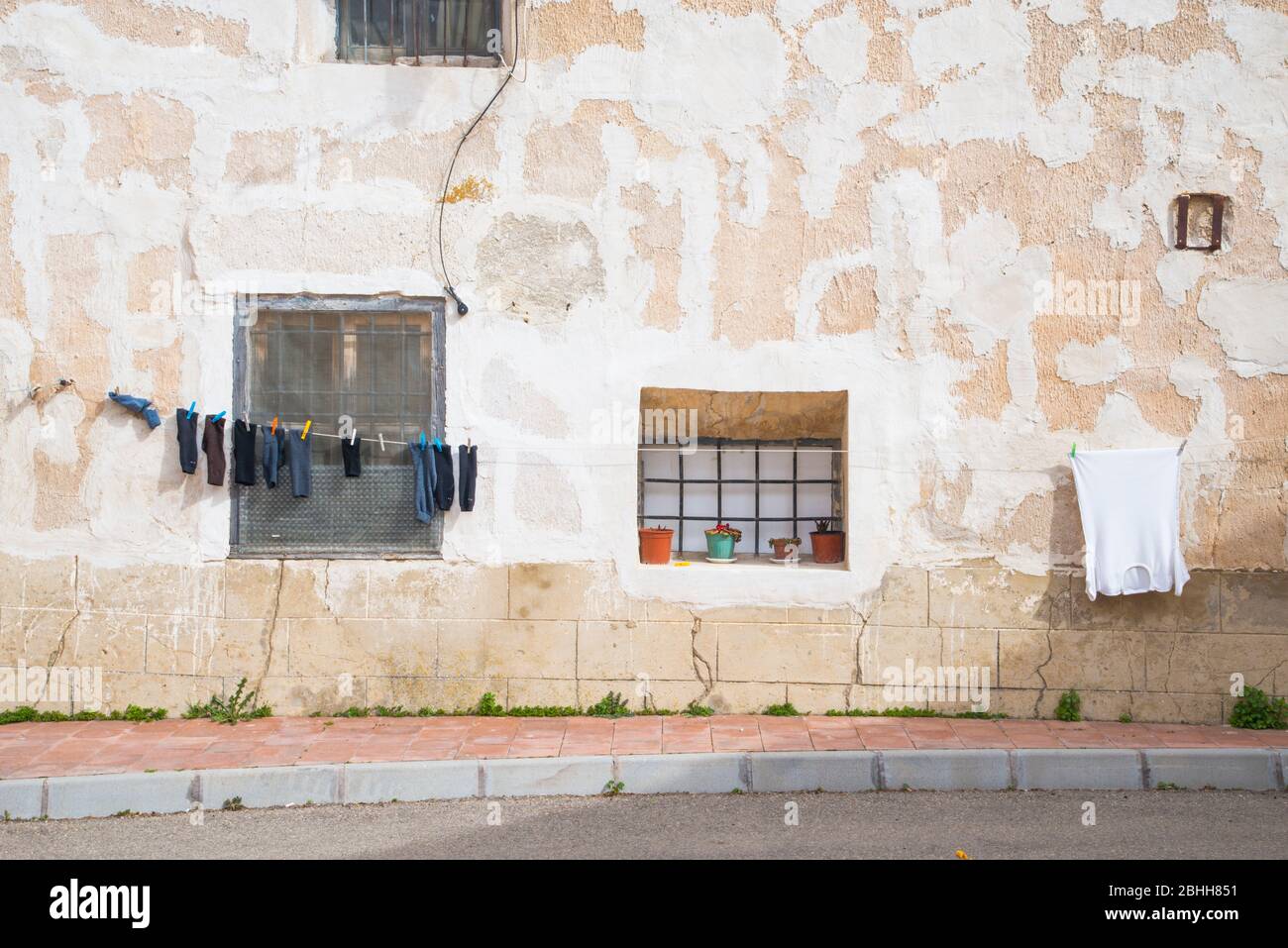 Facade of house and clothes on the line. Buendia, Cuenca province, Castilla La Mancha, Spain. Stock Photo