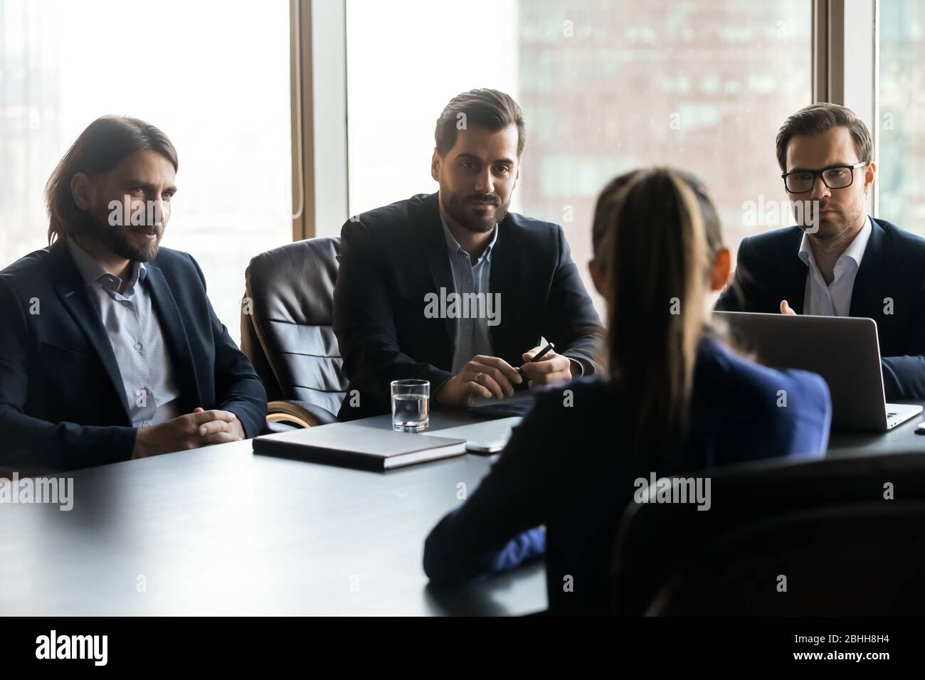 Three serious hr managers looking at candidate at meeting Stock Photo