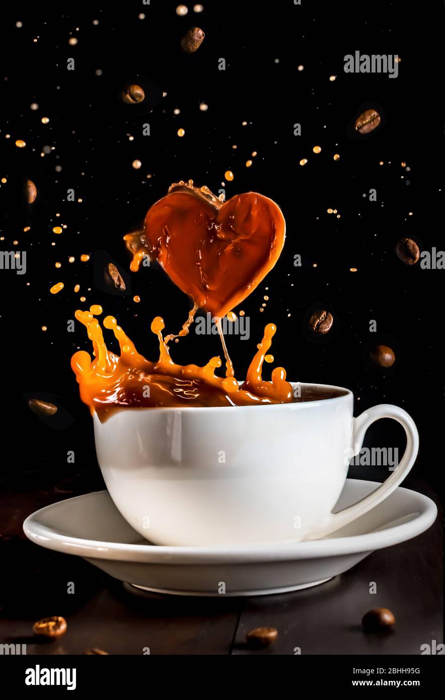 mug with coffee with splashes and coffee beans. coffee heart shape ...
