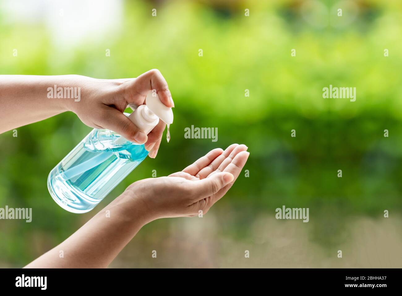 closeup cleaning hand using alocohol gel waterless in pump bottle