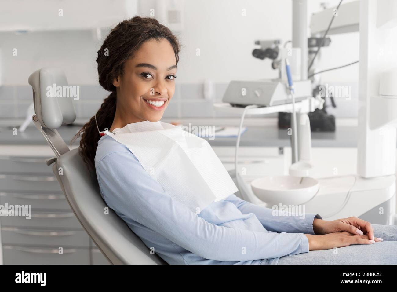 Young black lady sitting in dentist chair Stock Photo Alamy