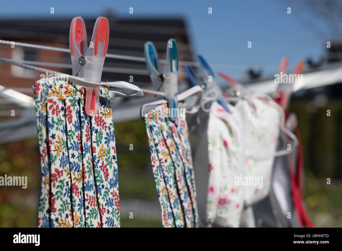 handmade face mask hanging on clothes line after washing Stock Photo