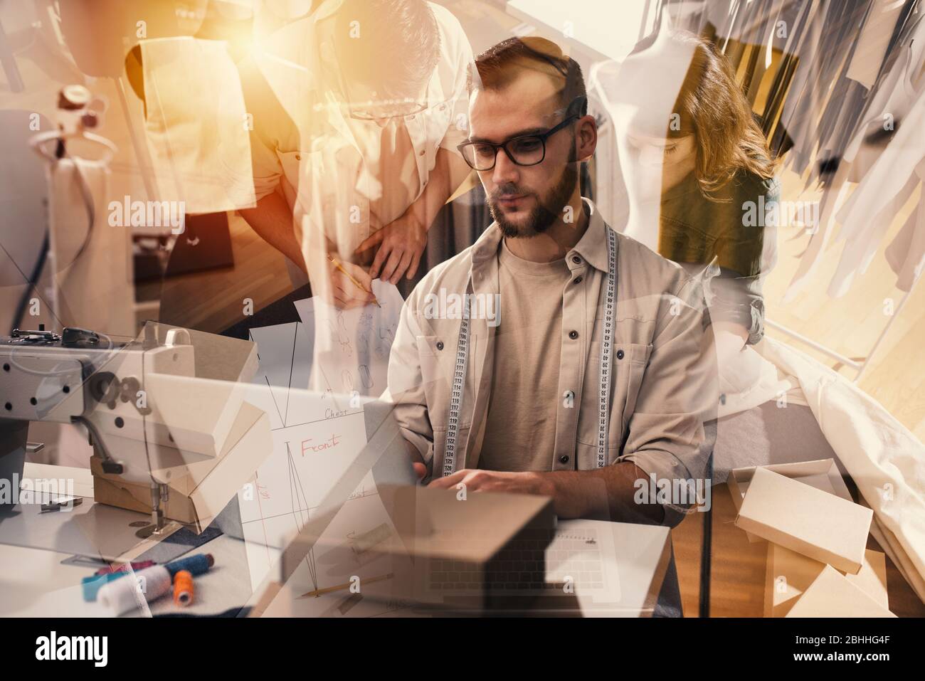 Seamstress works to new clothes ordered by internet client Stock Photo