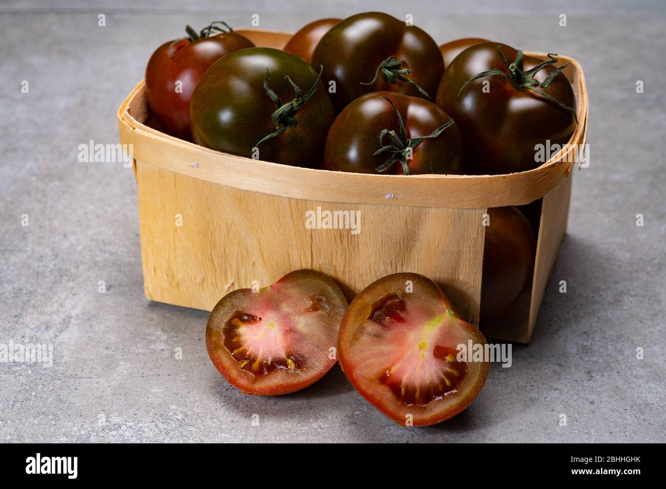 Fresh ripe sweet reddish brown and green kumato tomatoes close up Stock