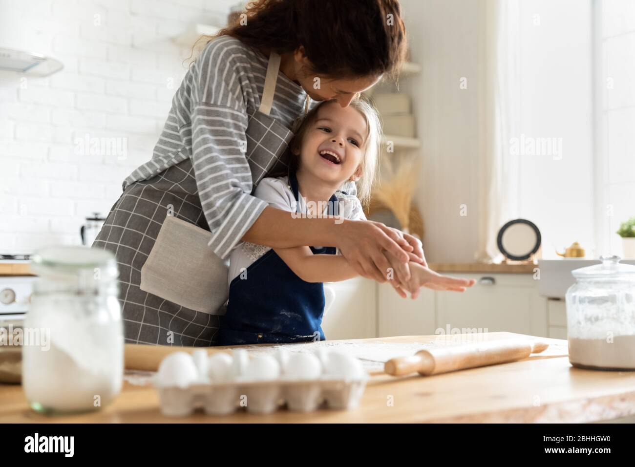 Happy adorable little child girl enjoying cooking with mother Stock ...