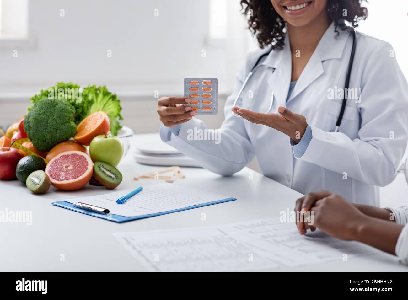 Cropped of african dietologist recommending slimming pills Stock Photo